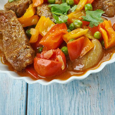 Filipino beef Caldereta, dish is cooked in a tomato-based sauce with vegetables